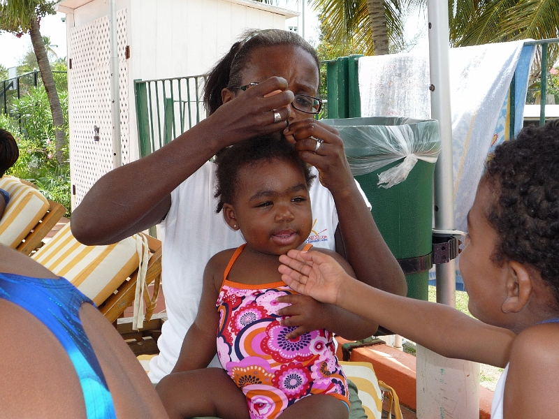 Antigua_Vacation_292b.JPG - Back at the pool for our last day of relaxation and sunshine.  Mikayla sits still for her aunt to braid her hair while cousin Ch� looks on