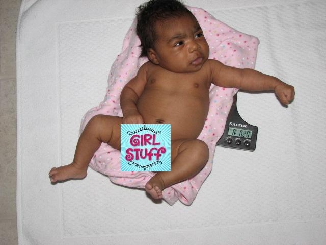 More_Mikayla_351-ed.JPG - Due to FCC regulation, this photo has been altered to protect the innocent.  You can just make out the scale numbers; she now weighs over 8lbs!!  Judging by her eating habits, she's trying to make up for the two weeks she missed in the womb!  You go Grrrl!! ([And for you fellow geeks out there, I did tare the container and blanket, and took into account the variation and speed of an unladen swallow.]