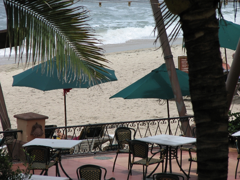 Puerto_Vallarta_008.JPG - Beach and surf between the trees.  Beaches are public property in Mexico.