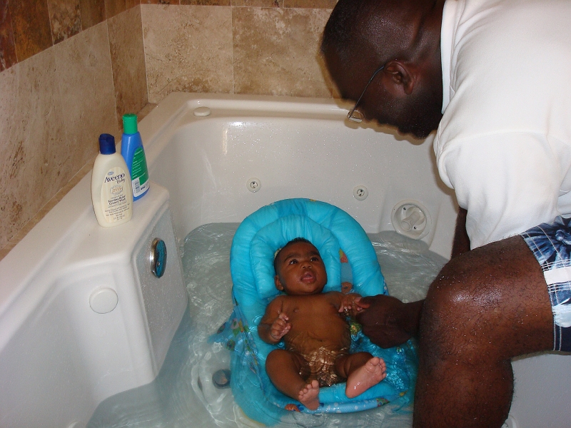 Puerto_Vallarta_080.jpg - Giving Mikayla a bath in the master bedroom's jacuzzi.  Don't worry, no suds or jets and just warm water. She loves it!