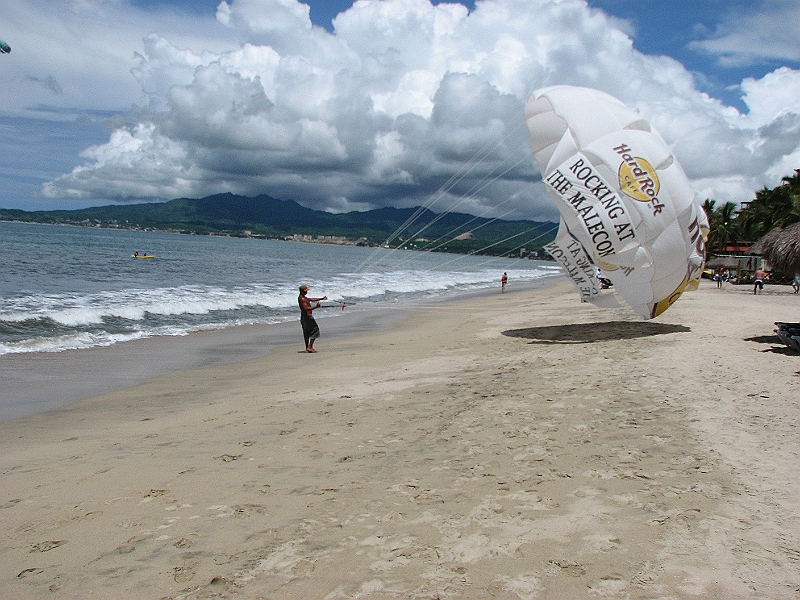Puerto_Vallarta_207.JPG - Back safely on the beach.  That the same parachute I just went up in.  Kim and I wanted to do a tandem run, but apparently the coast guard or harbor master banned it. :-(  Kim will go next time...right Kim?
